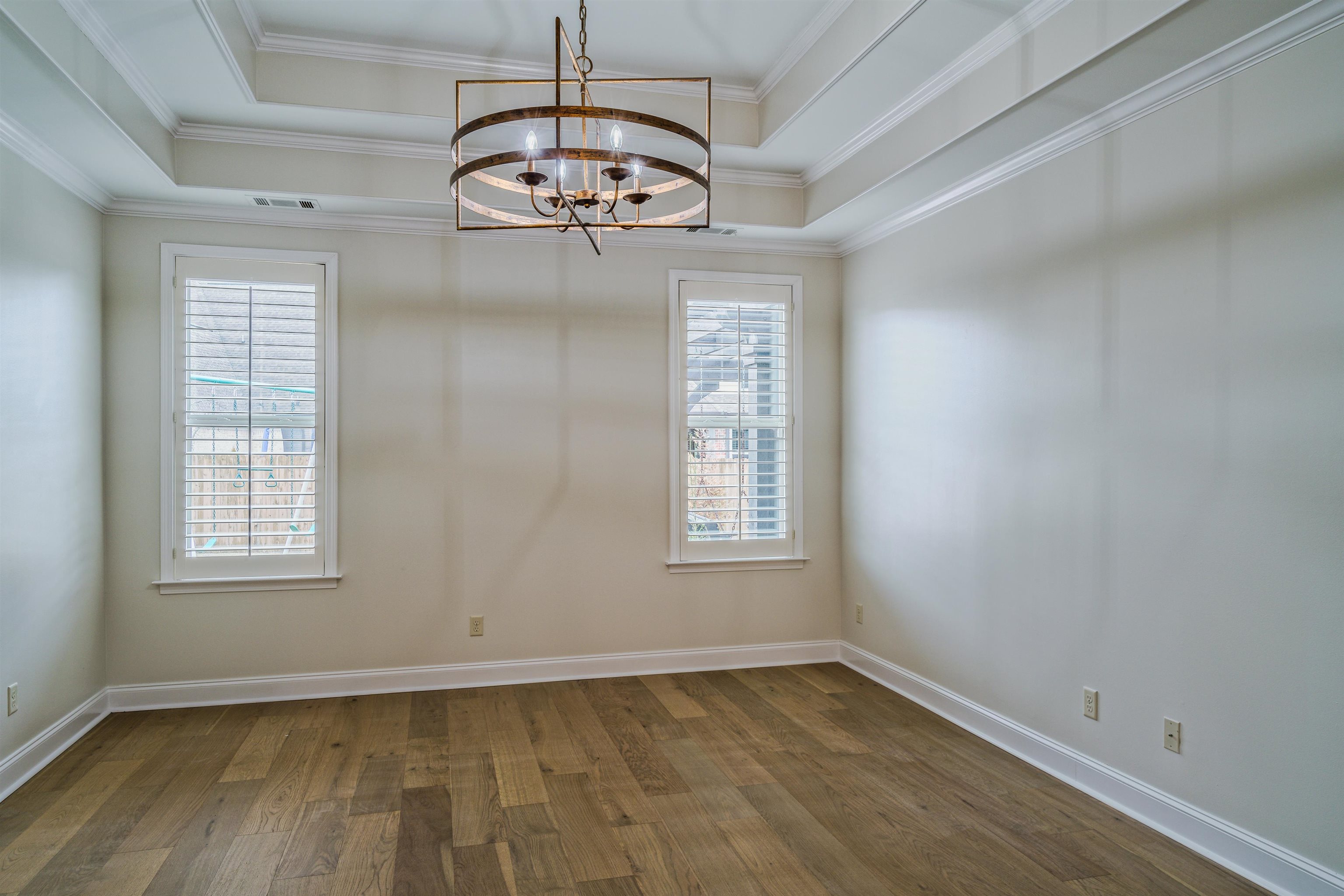 1361 Conser Street Collierville, TN 38017 - Photo 13 of 25 an empty room with wooden floor chandelier and window