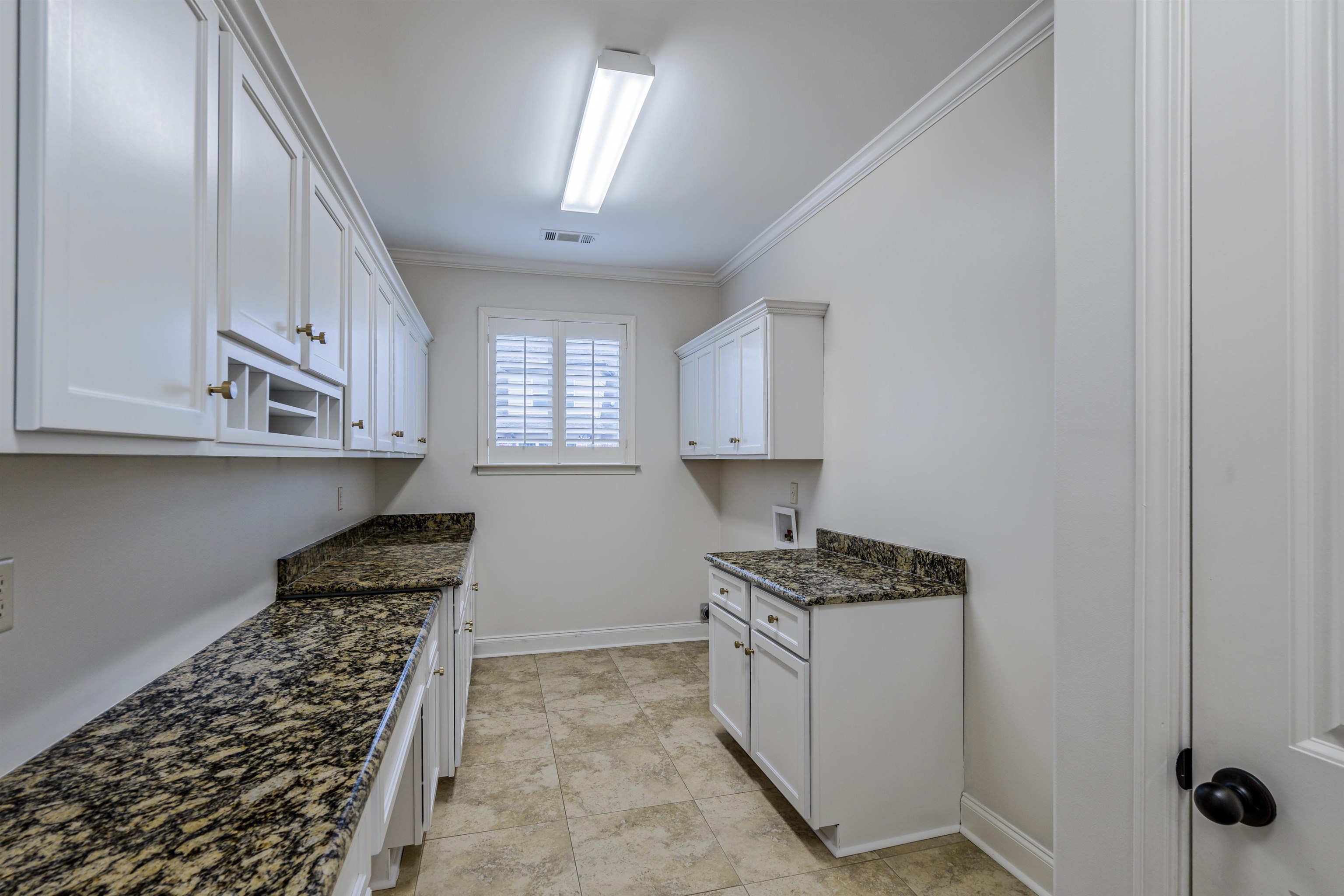 1361 Conser Street Collierville, TN 38017 - Photo 24 of 25 a kitchen with granite countertop a sink stove and cabinets