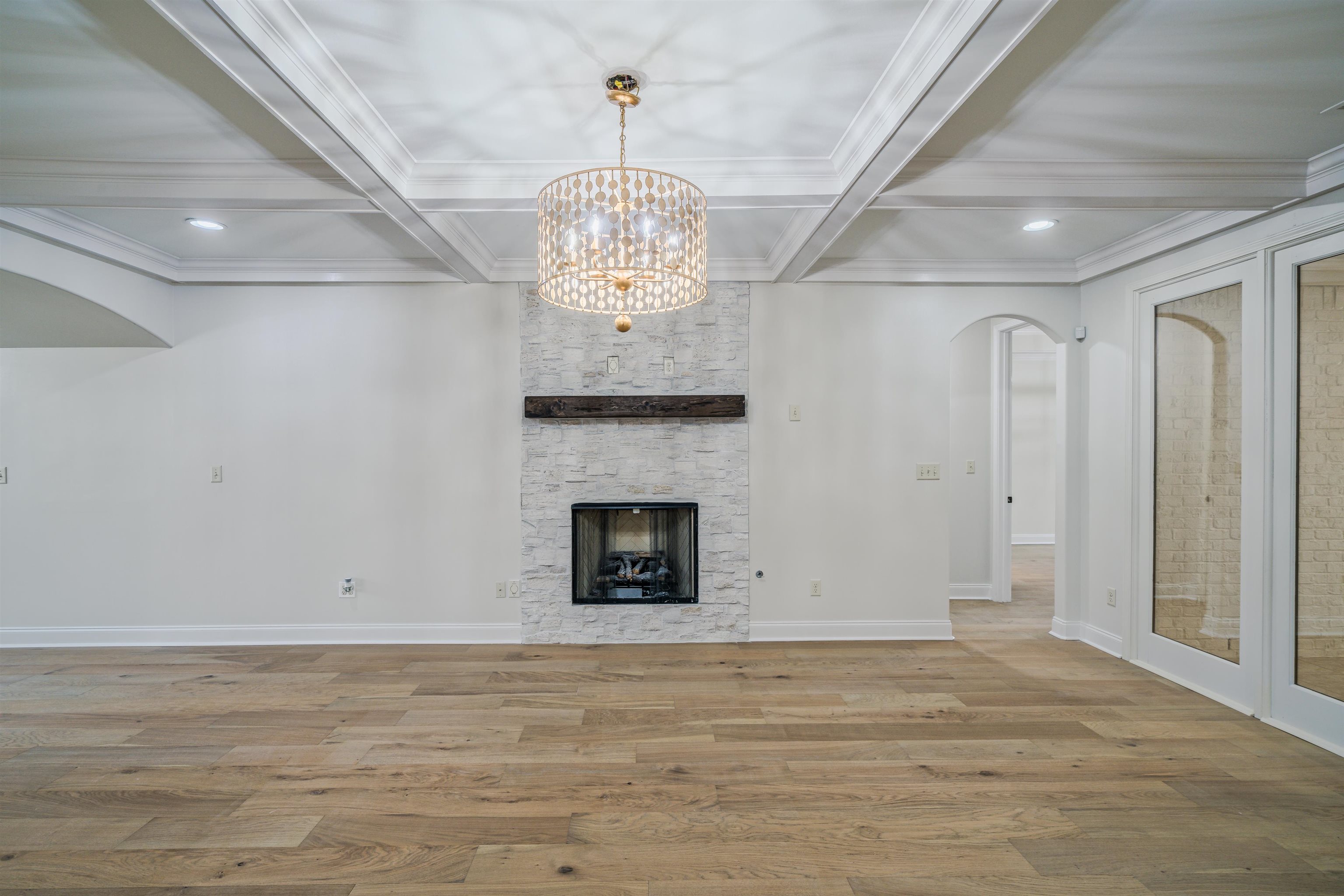 1361 Conser Street Collierville, TN 38017 - Photo 5 of 25 a view of a livingroom with a fireplace a chandelier and wooden floor