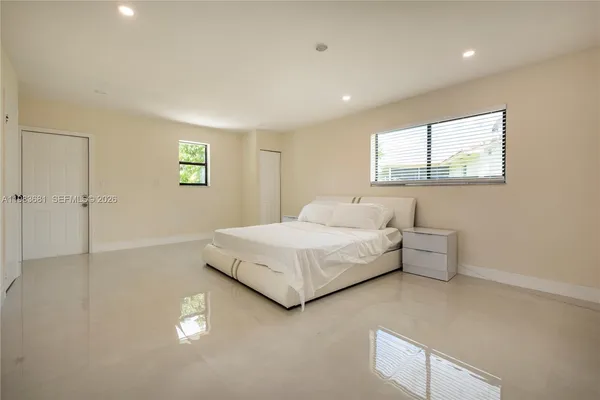 a bedroom with a bed and a window