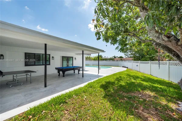 a view of a backyard with sitting area