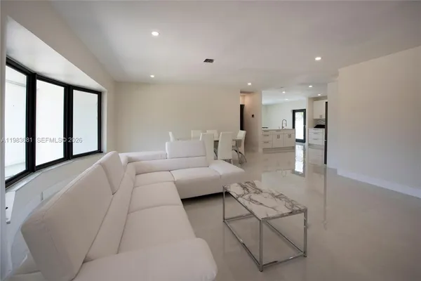 a living room with furniture and a large window