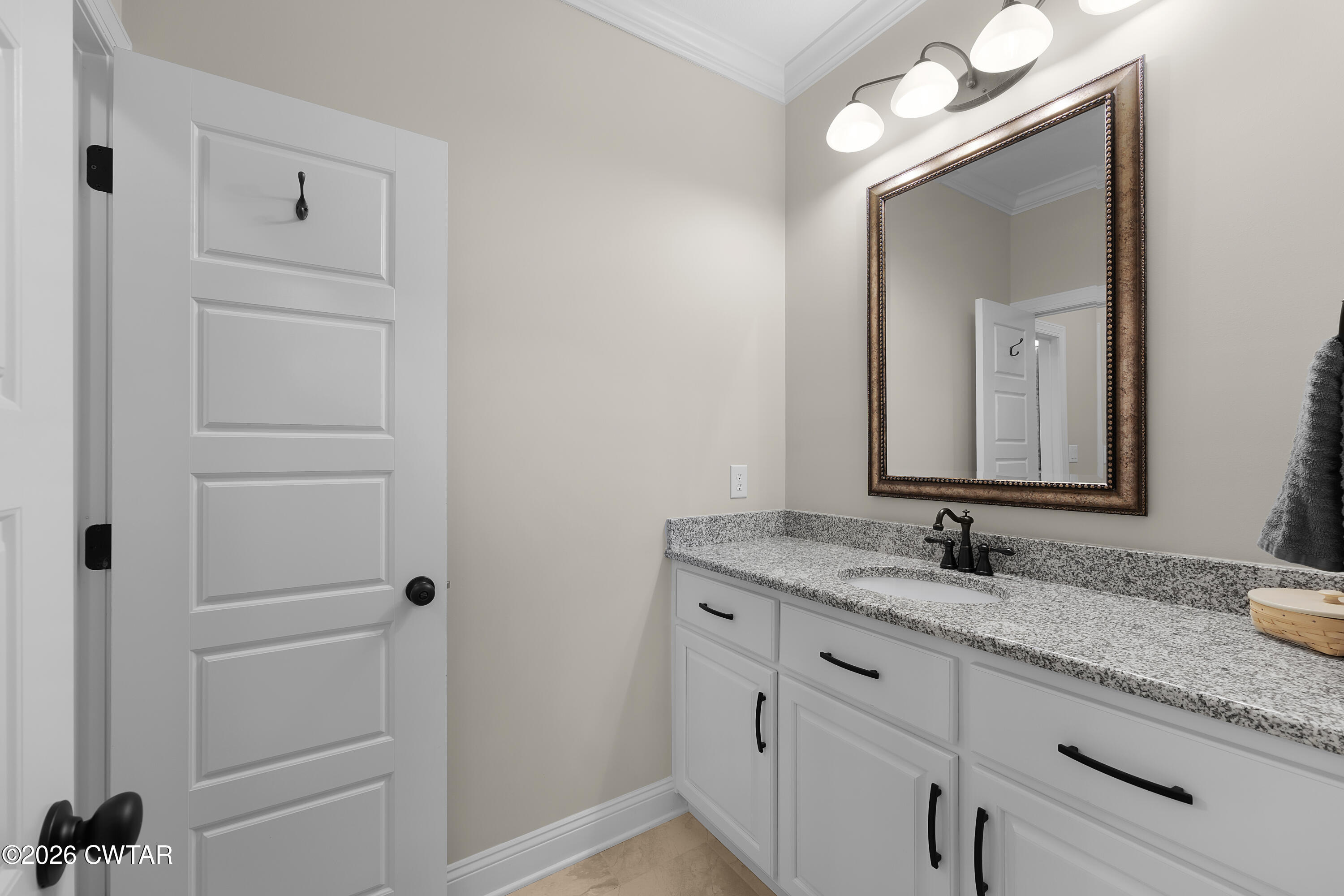 34 Cheddleton Cove Jackson, TN 38305 - Photo 23 of 32 a bathroom with a granite countertop sink vanity and mirror