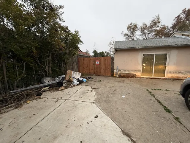 a backyard of a house with table and chairs