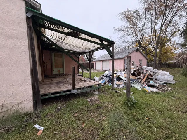 a view of a backyard with a patio table and chairs