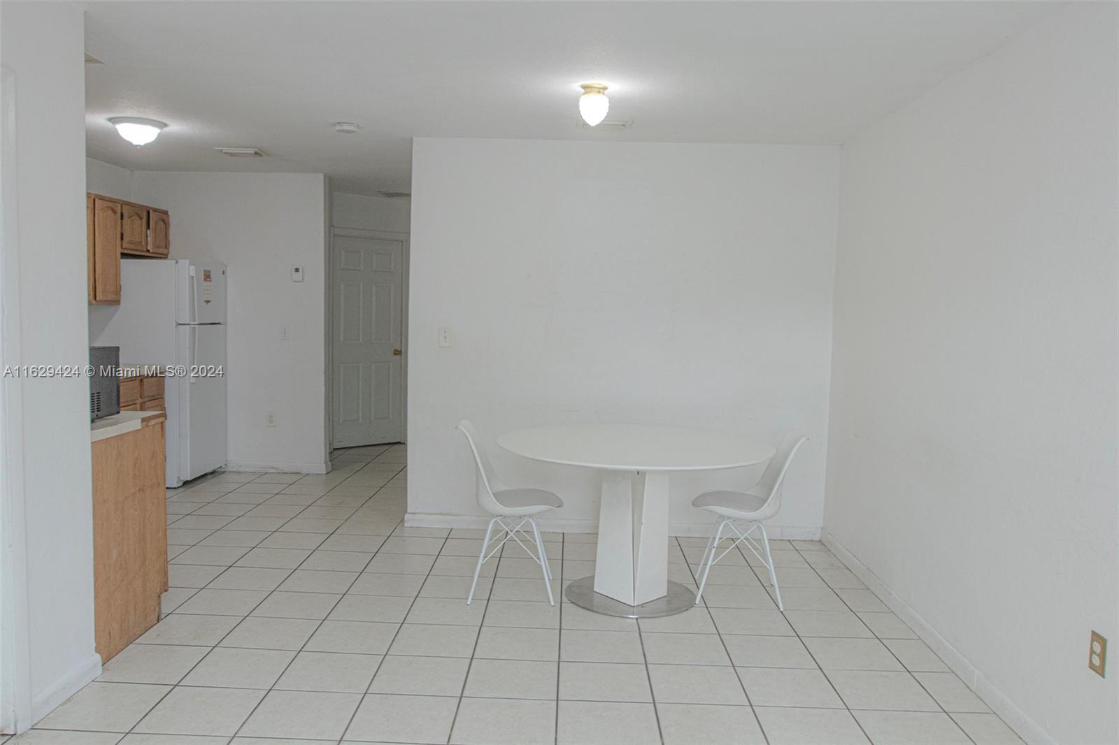 14316 Southwest 283rd Street, Unit 14316 Homestead, FL 33033 - Photo 2 of 6 a view of an empty room with cabinet and mirrors