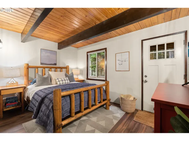 a bedroom with a bed next to a window