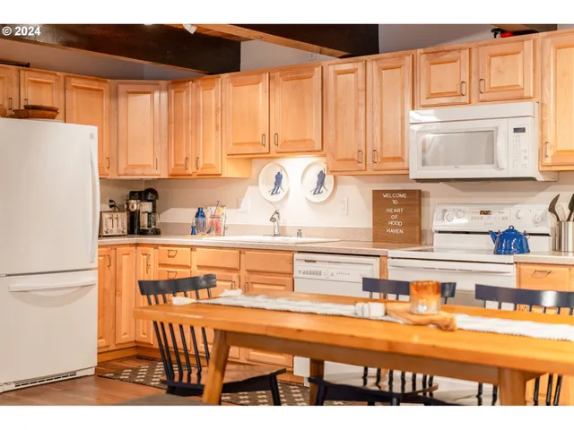 a kitchen with stainless steel appliances granite countertop a refrigerator and sink