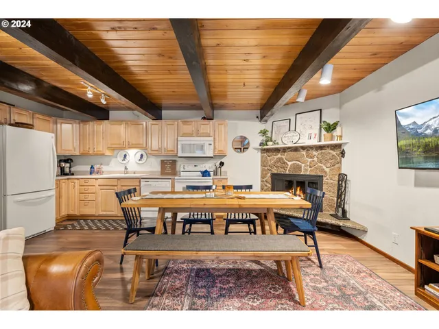 a living room with a couch a dining table and kitchen view