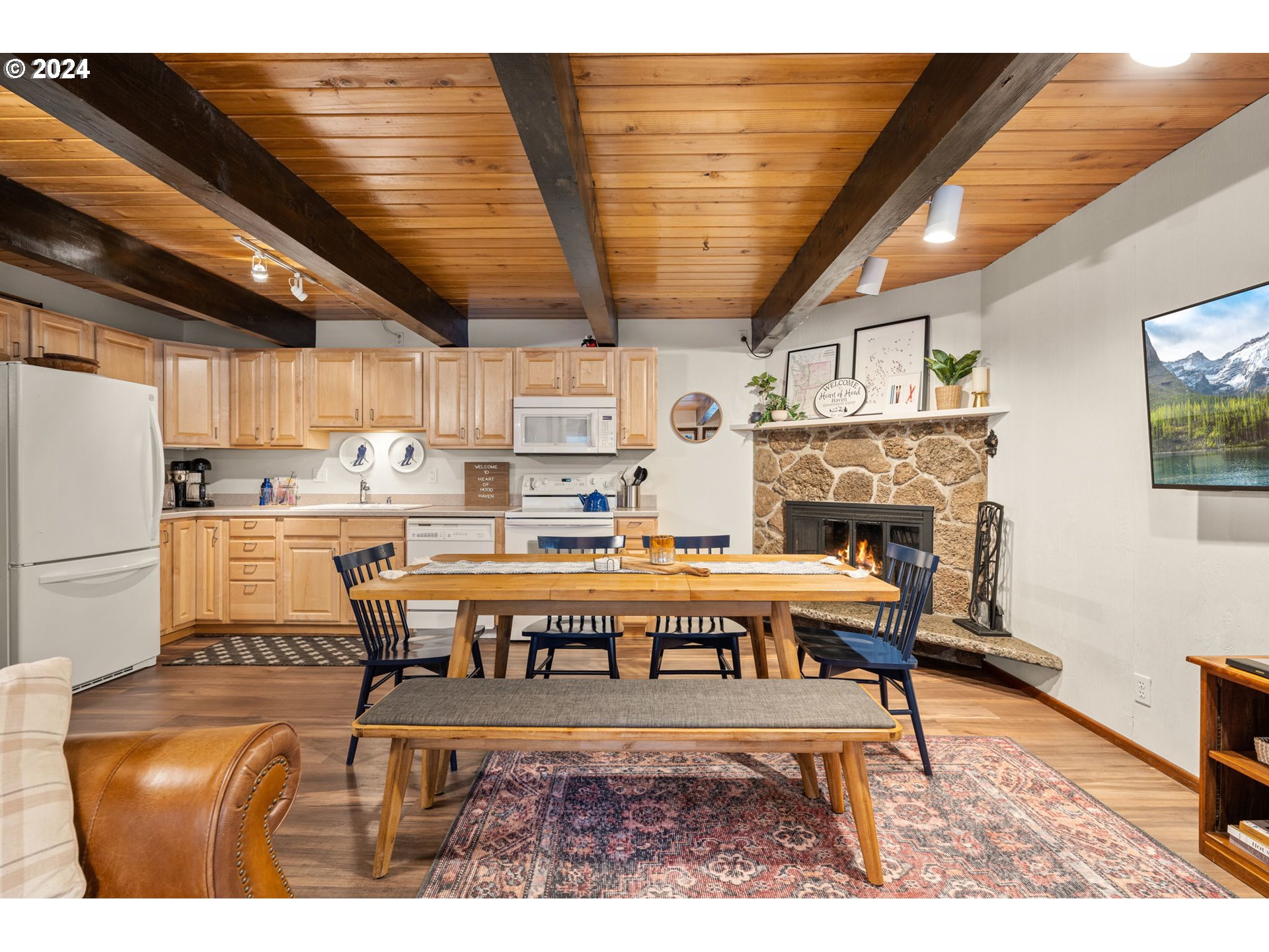 88460 Government Camp Loop, Unit 8 Government Camp, OR 97028 - Photo 4 of 38 a living room with a couch a dining table and kitchen view