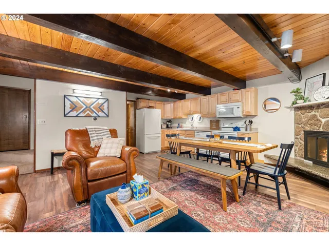a living room with furniture a rug and a table