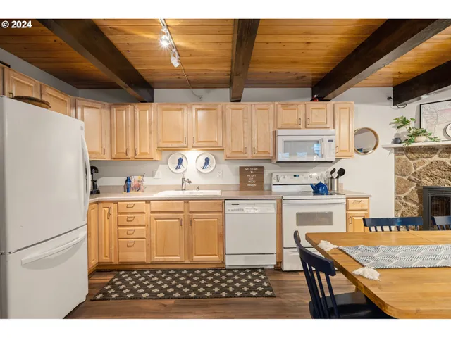 a kitchen with kitchen island granite countertop a sink appliances cabinets and a counter top space