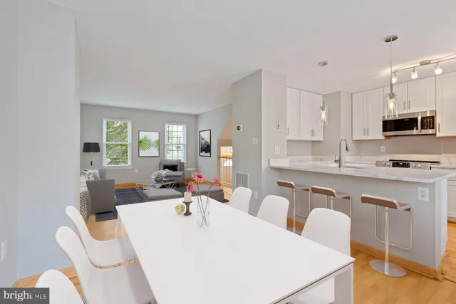 a kitchen with sink a faucet and chandelier