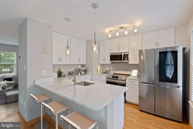 a bathroom with a granite countertop sink a toilet and shower