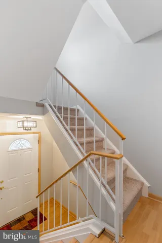 an empty room with windows and chandelier fan