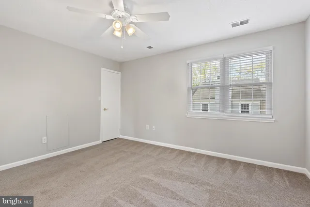a view of an empty room with a fireplace