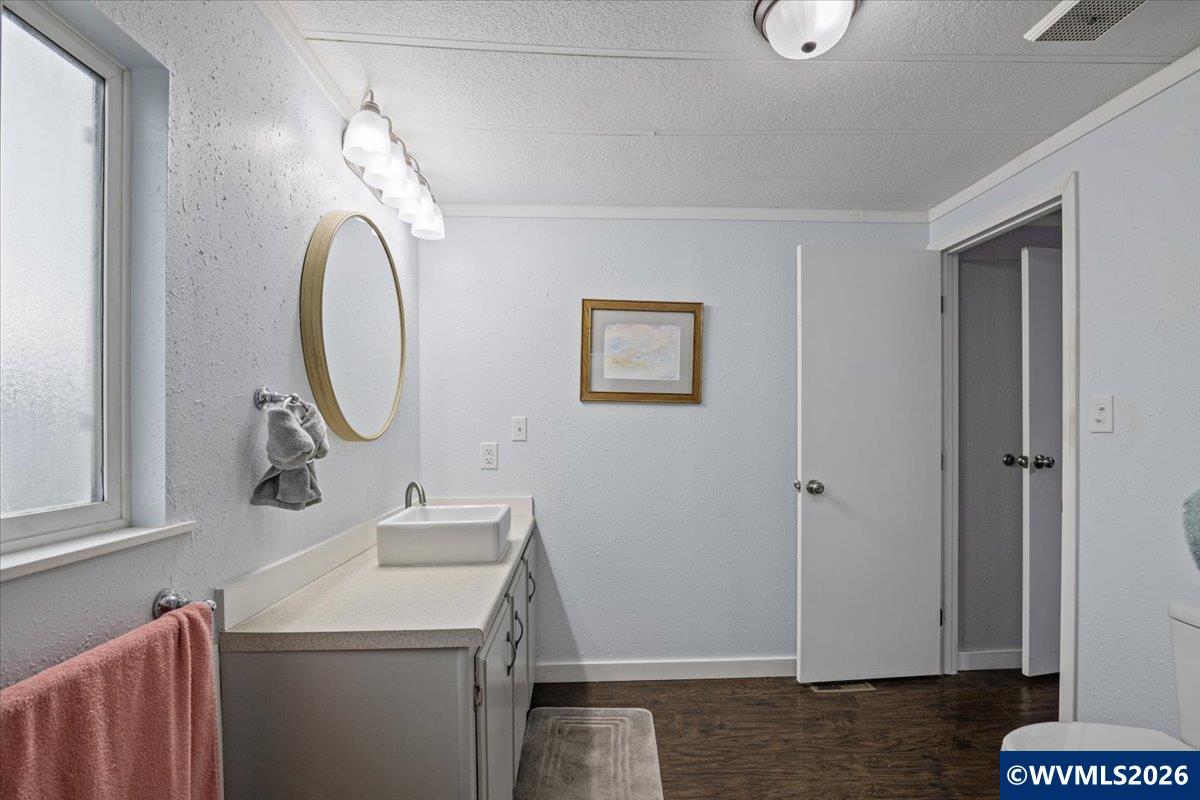 5422 Portland Road Northeast, Unit 123 Salem, OR 97305 - Photo 23 of 23 a bathroom with a sink a toilet and a mirror