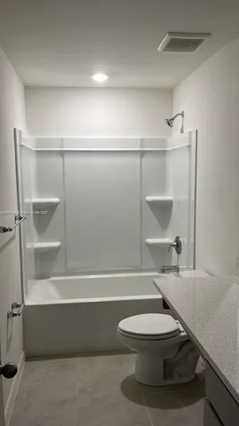 a bathroom with a toilet and a bathtub