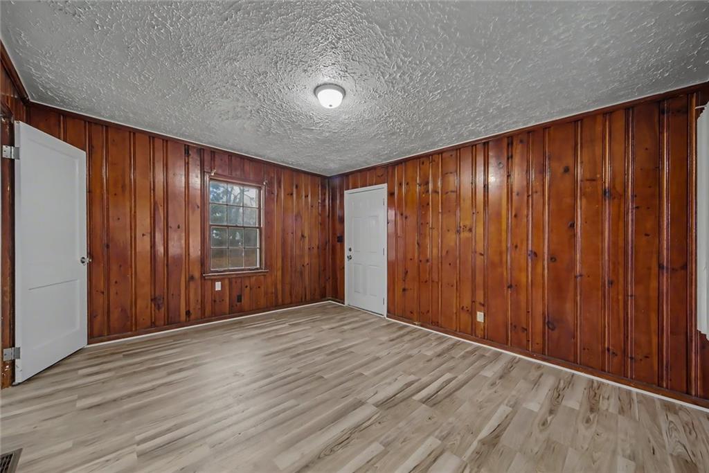 725 Matilda Place Northwest Atlanta, GA 30318 - Photo 16 of 28 an empty room with wooden floor and windows