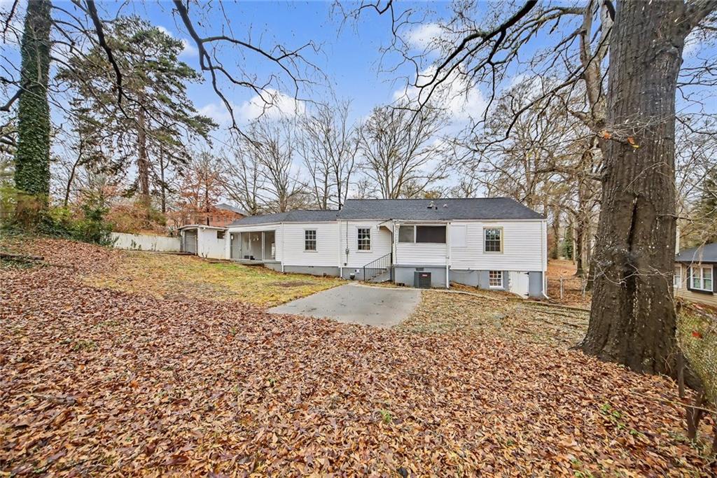 725 Matilda Place Northwest Atlanta, GA 30318 - Photo 26 of 28 a front view of a house with a yard and trees