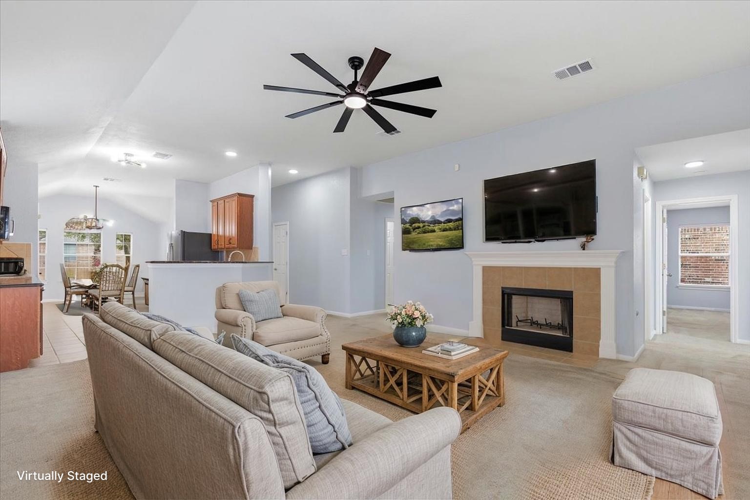 17812 Masi Loop Pflugerville, TX 78660 - Photo 15 of 38 Inviting living area featuring a fireplace with a light-colored tile surround and mantel