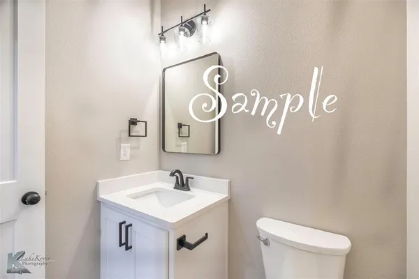 a bathroom with a sink a toilet and mirror