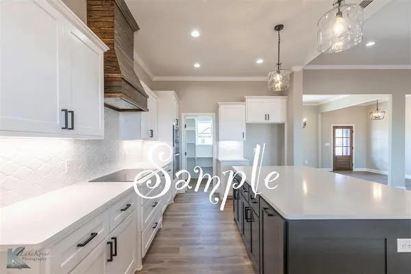 a kitchen with stainless steel appliances granite countertop a lot of counter space and wooden floors