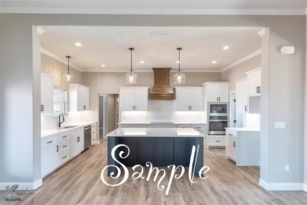 a large kitchen with a lot of counter space and refrigerator