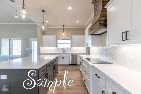 a kitchen with stainless steel appliances granite countertop a sink a stove and a refrigerator