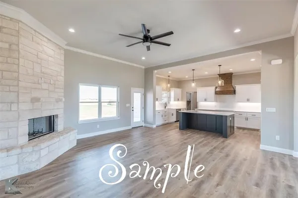 a open kitchen with a refrigerator a sink dishwasher with a fireplace and wooden floor