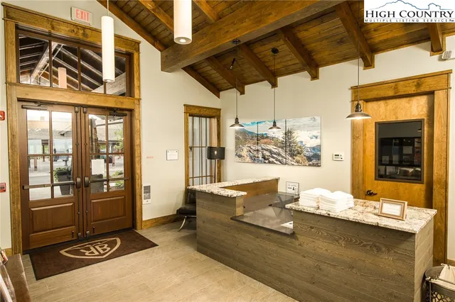 a very nice looking room with many windows and furniture