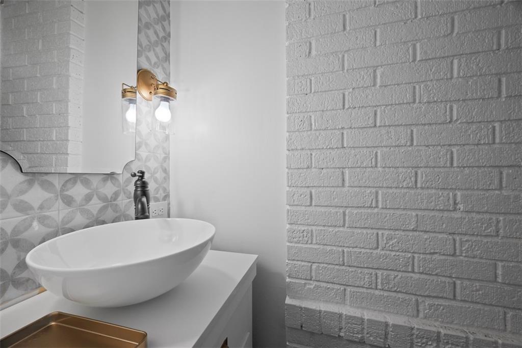 853 West Ingomar Road Pittsburgh, PA 15237 - Photo 22 of 50 The vessel sink vanity with exposed brick wall and stylish backsplash are a real treat to all of your guests.