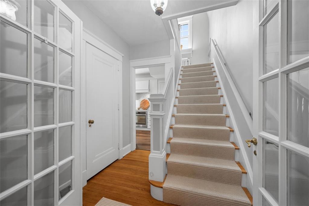 853 West Ingomar Road Pittsburgh, PA 15237 - Photo 23 of 50 Two glass French doors can close off the front staircase that features a carpet runner with wood tread risers.