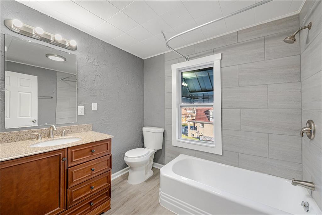 1222 Valley Street McKees Rocks, PA 15136 - Photo 13 of 13 a bathroom with a sink a toilet and bathtub