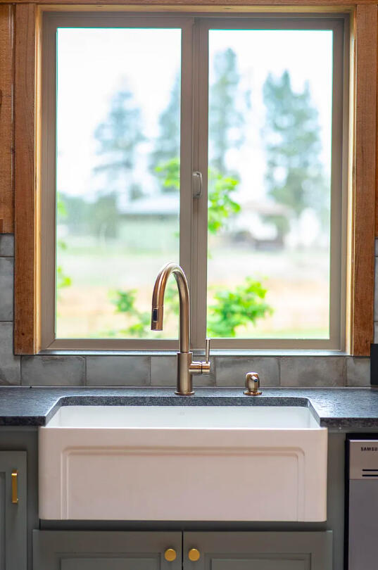 60359 Arnold Market Road Bend, OR 97702 - Photo 16 of 64 farmhouse sink overlooking horse butte farms and cascade mountain views. Leathered steel-grey granite countertops