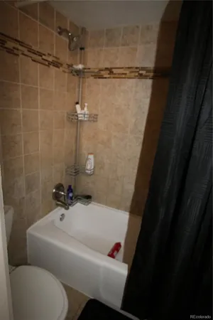 a bathroom with a bathtub and shower