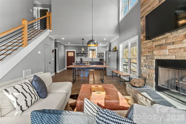 a living room with furniture a fireplace and wooden floor