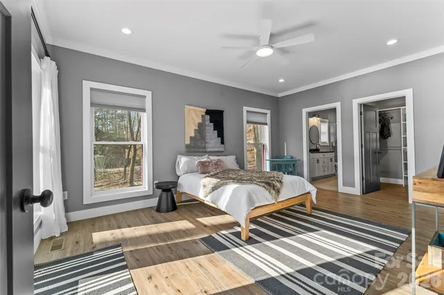 a bed room with a bed and a large window