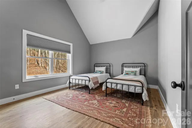 a spacious bedroom with two beds and a window