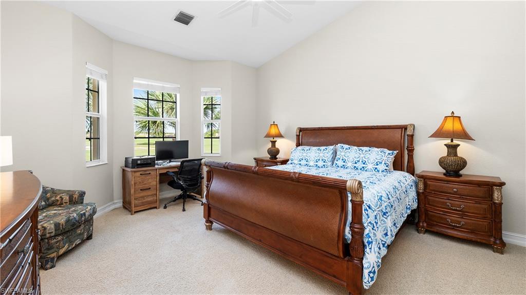 8617 Champions Point, Unit 403 Naples, FL 34113 - Photo 16 of 37 Carpeted bedroom featuring a desk, lofted ceiling, and a ceiling fan
