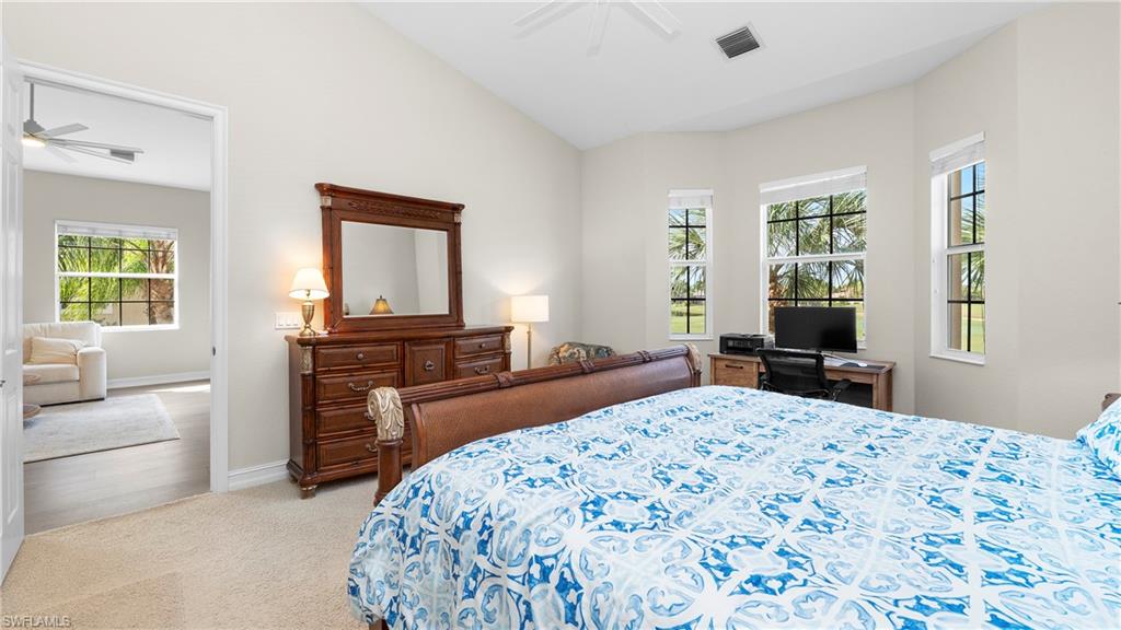 8617 Champions Point, Unit 403 Naples, FL 34113 - Photo 17 of 37 Bedroom featuring lofted ceiling, carpet, and a ceiling fan