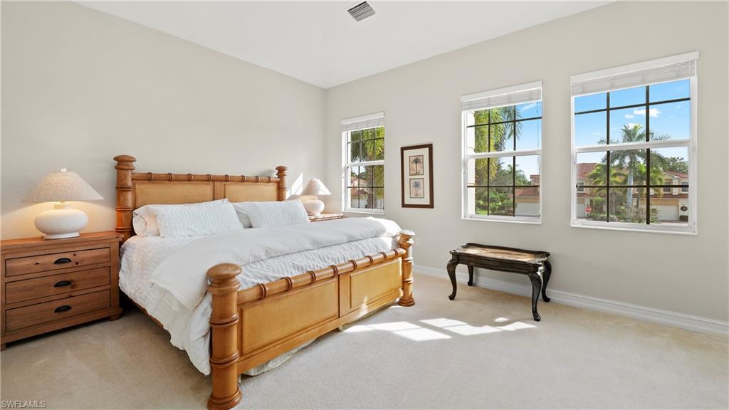 8617 Champions Point, Unit 403 Naples, FL 34113 - Photo 21 of 37 Carpeted bedroom with baseboards