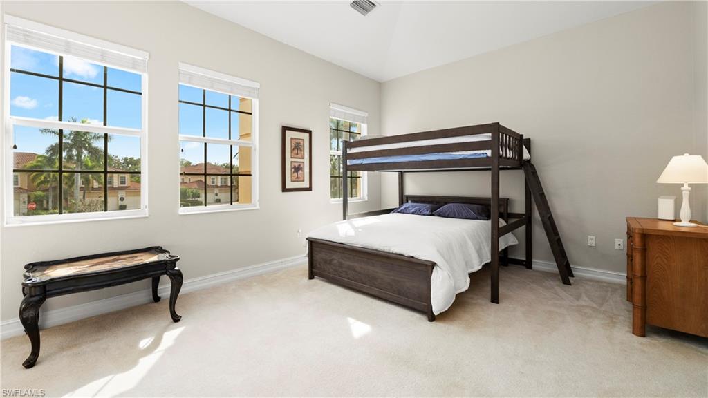 8617 Champions Point, Unit 403 Naples, FL 34113 - Photo 24 of 37 Bedroom with light carpet and baseboards