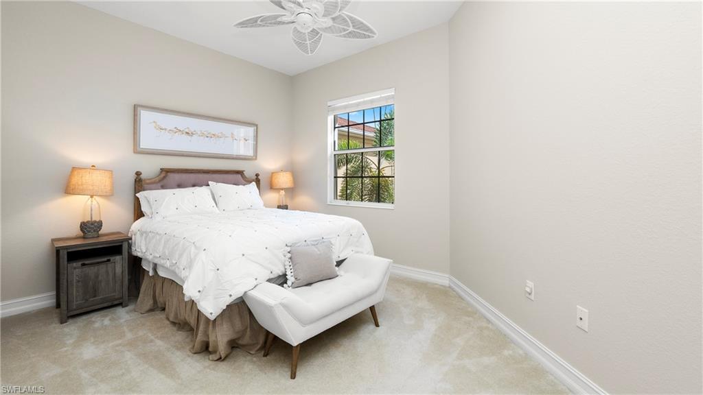 8617 Champions Point, Unit 403 Naples, FL 34113 - Photo 26 of 37 Carpeted bedroom with baseboards