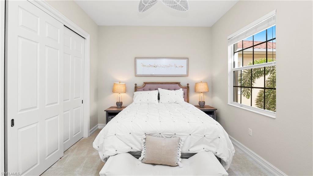 8617 Champions Point, Unit 403 Naples, FL 34113 - Photo 27 of 37 Carpeted bedroom with a closet and ceiling fan
