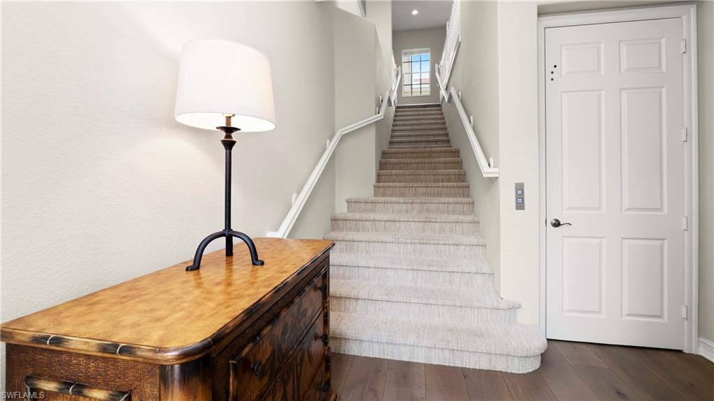 8617 Champions Point, Unit 403 Naples, FL 34113 - Photo 30 of 37 Staircase featuring hardwood / wood-style floors and recessed lighting