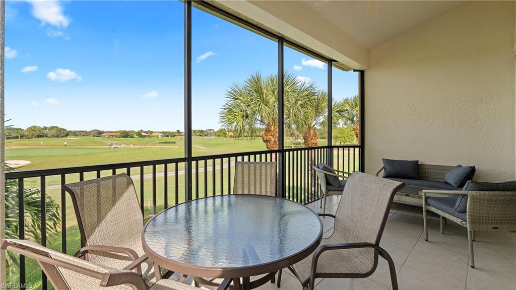 8617 Champions Point, Unit 403 Naples, FL 34113 - Photo 3 of 37 Sunroom with a balcony, golf course view, lofted ceiling, and outdoor dining area
