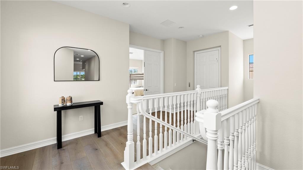 8617 Champions Point, Unit 403 Naples, FL 34113 - Photo 31 of 37 Hall featuring an upstairs landing, light wood-style floors, and recessed lighting