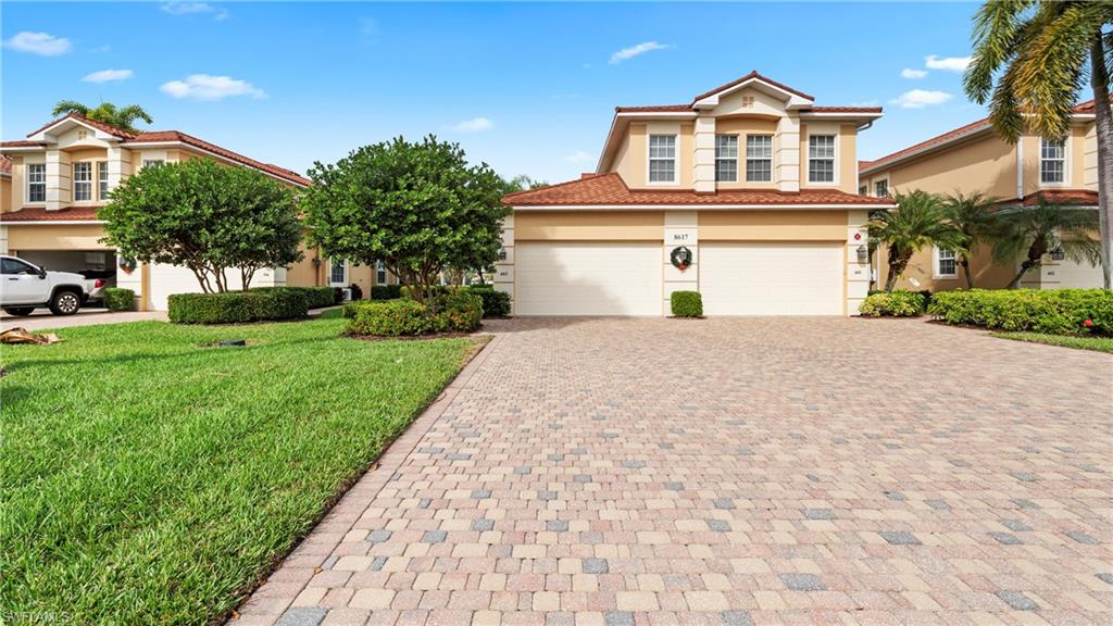 8617 Champions Point, Unit 403 Naples, FL 34113 - Photo 34 of 37 Mediterranean / spanish house with stucco siding, decorative driveway, a front yard, and a tile roof
