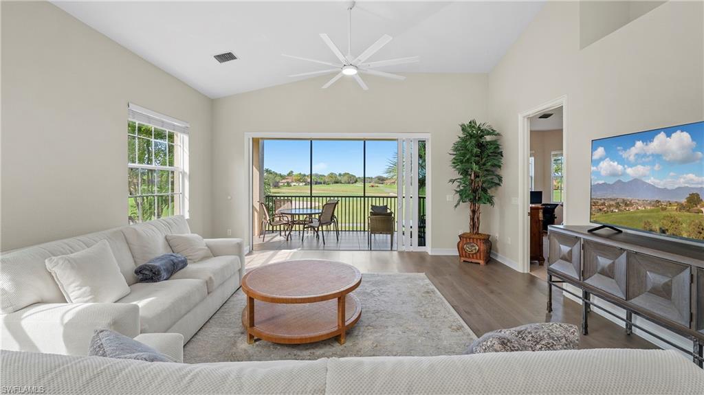 8617 Champions Point, Unit 403 Naples, FL 34113 - Photo 4 of 37 Bright and open main living area filled with natural light - looking out over the gorgeous Mustang Course of Lely